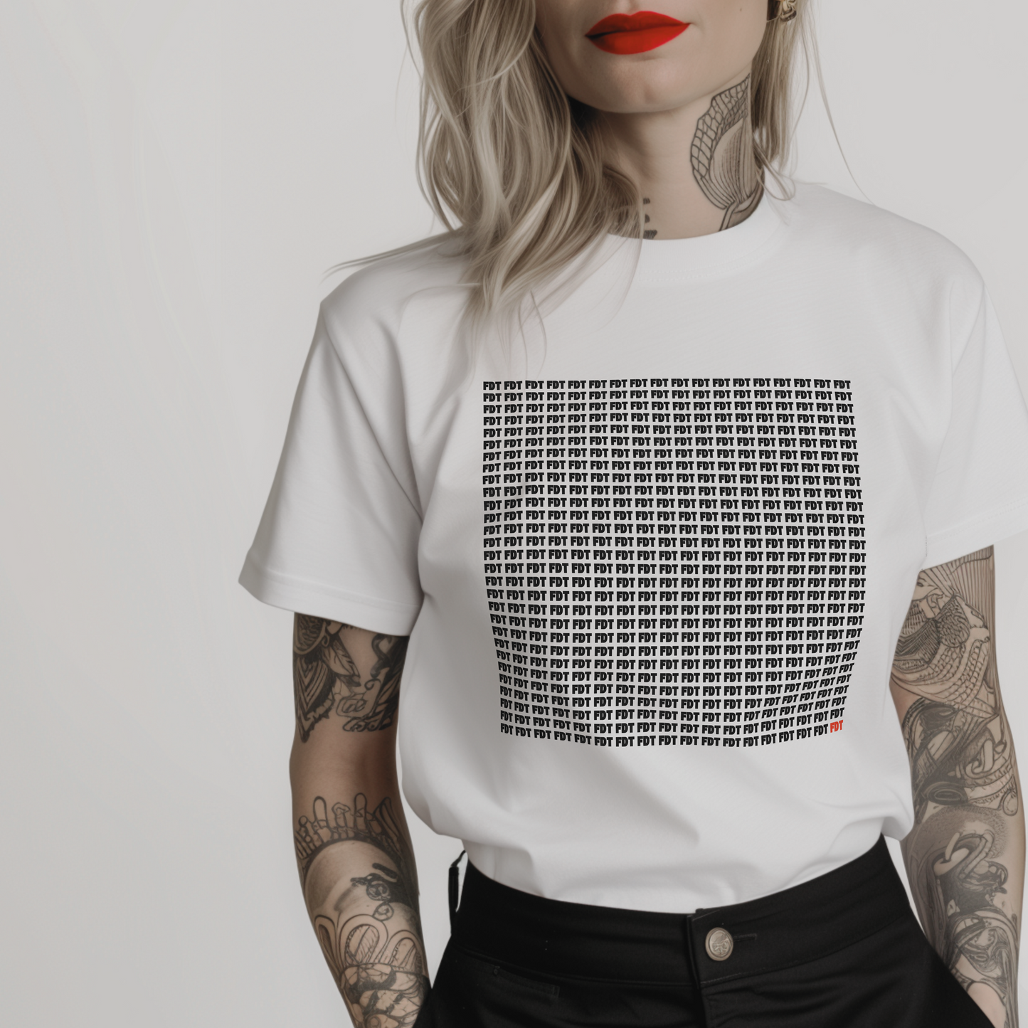 Women’s minimalist t-shirt with the anti trump symbol FDT (for: fuck donald trump) on repeat (exactly 522 times) in a simple design and white color.