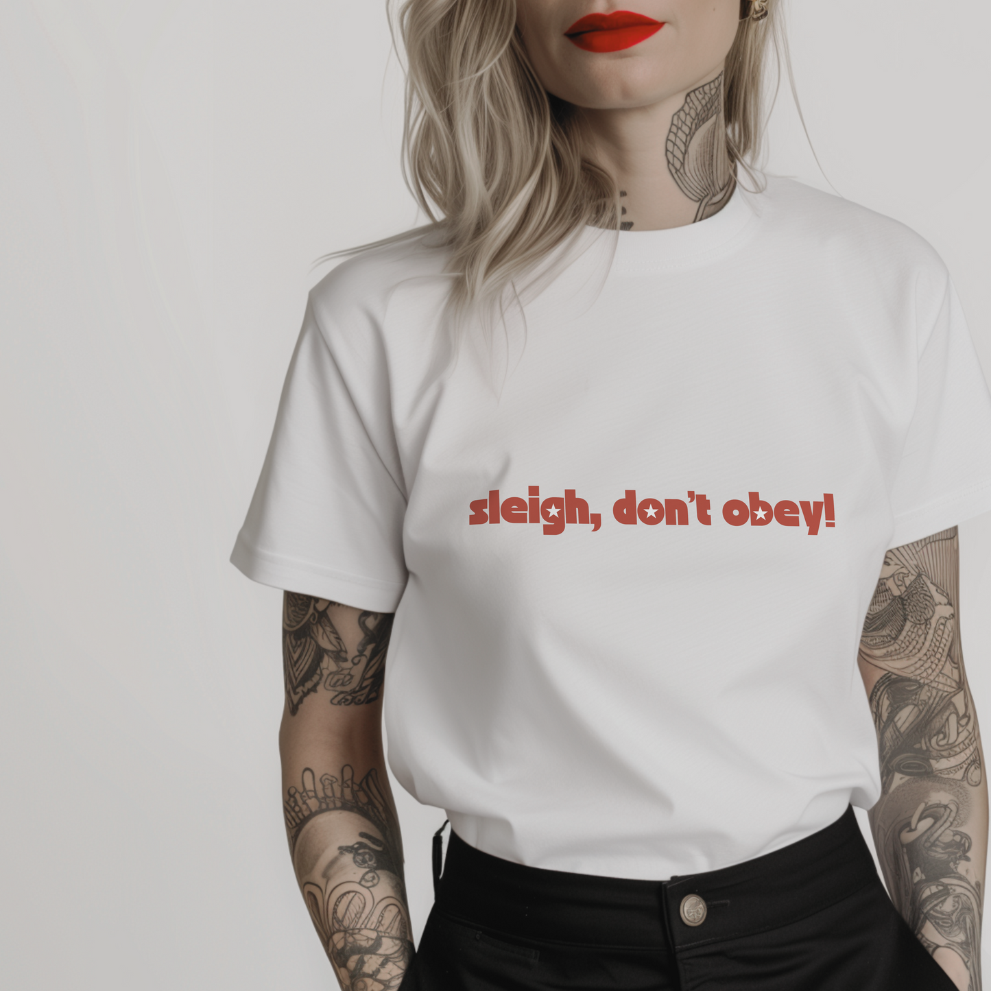 Women’s minimalist t-shirt with the feminist quote 'sleigh, don’t obey!' in a simple design and white color.