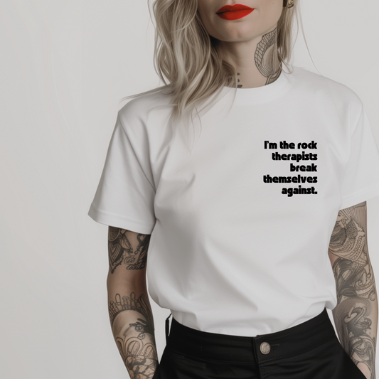 Women’s minimalist t-shirt with the quote 'I'm the rock therapists break themselves against.' in a simple design and white color.