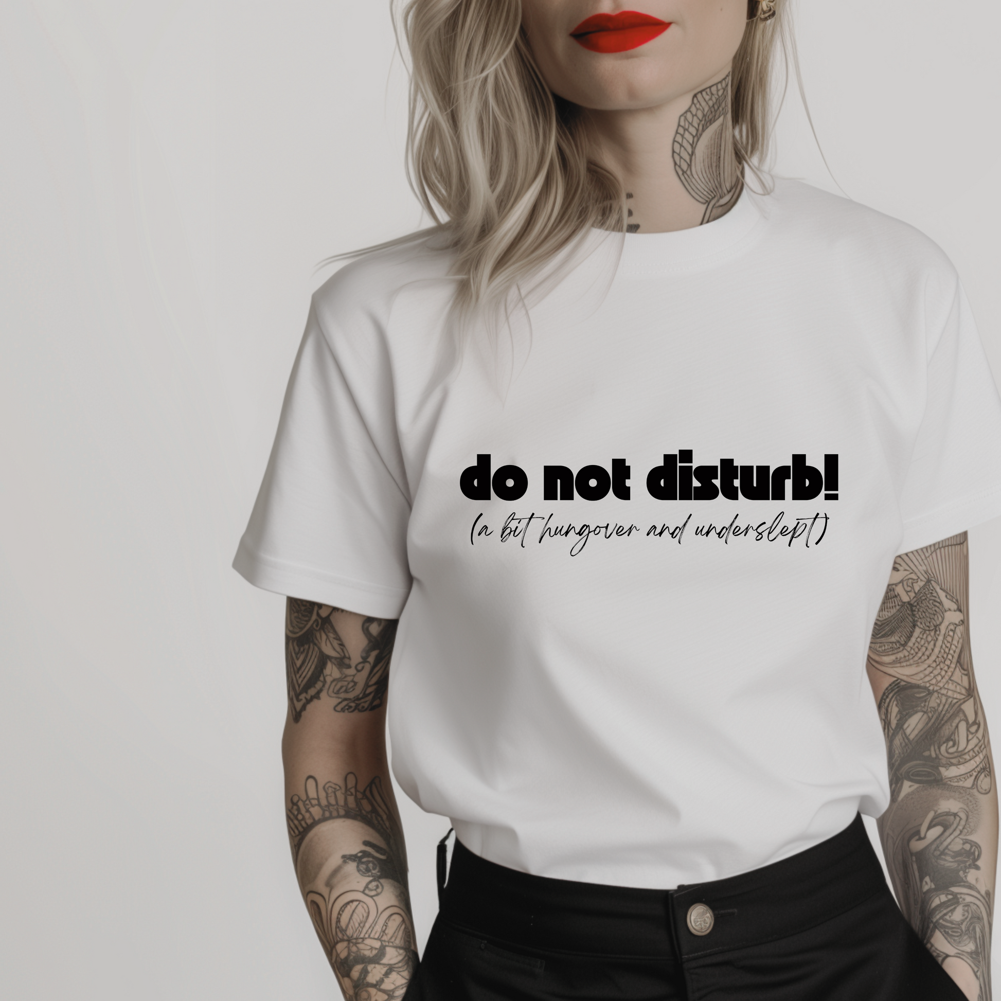 Women’s minimalist t-shirt with the quote 'do not disturb! (a bit hungover and underslept)' in a simple design and white color.