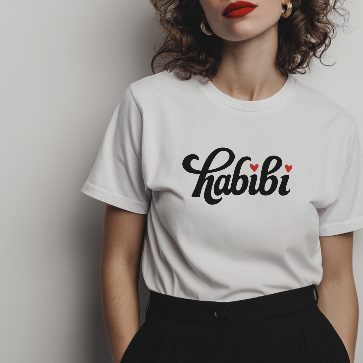 a white statement t-shirt with Arabic phrase 'habibi' and heart two symbols