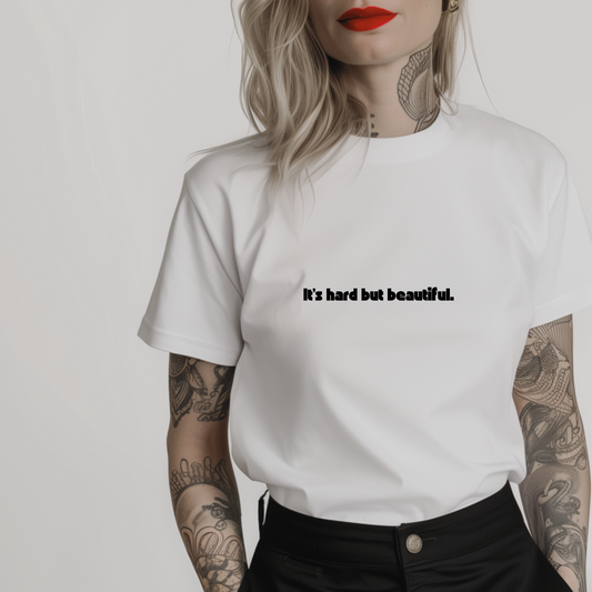 Women’s minimalist t-shirt with the quote 'It's hard but beautiful.' in a simple design and white color.