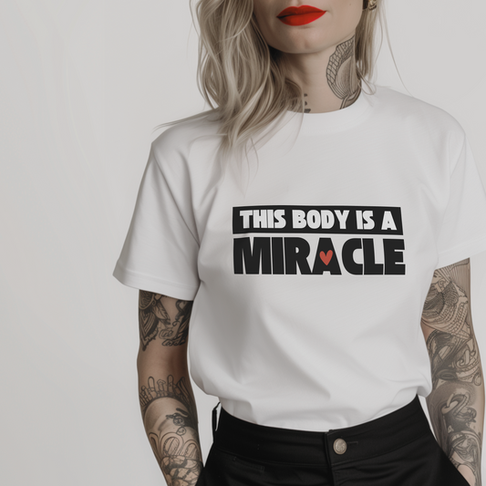 Women’s minimalist t-shirt with the body positive quote 'This body is a miracle.' in a simple design and white color.