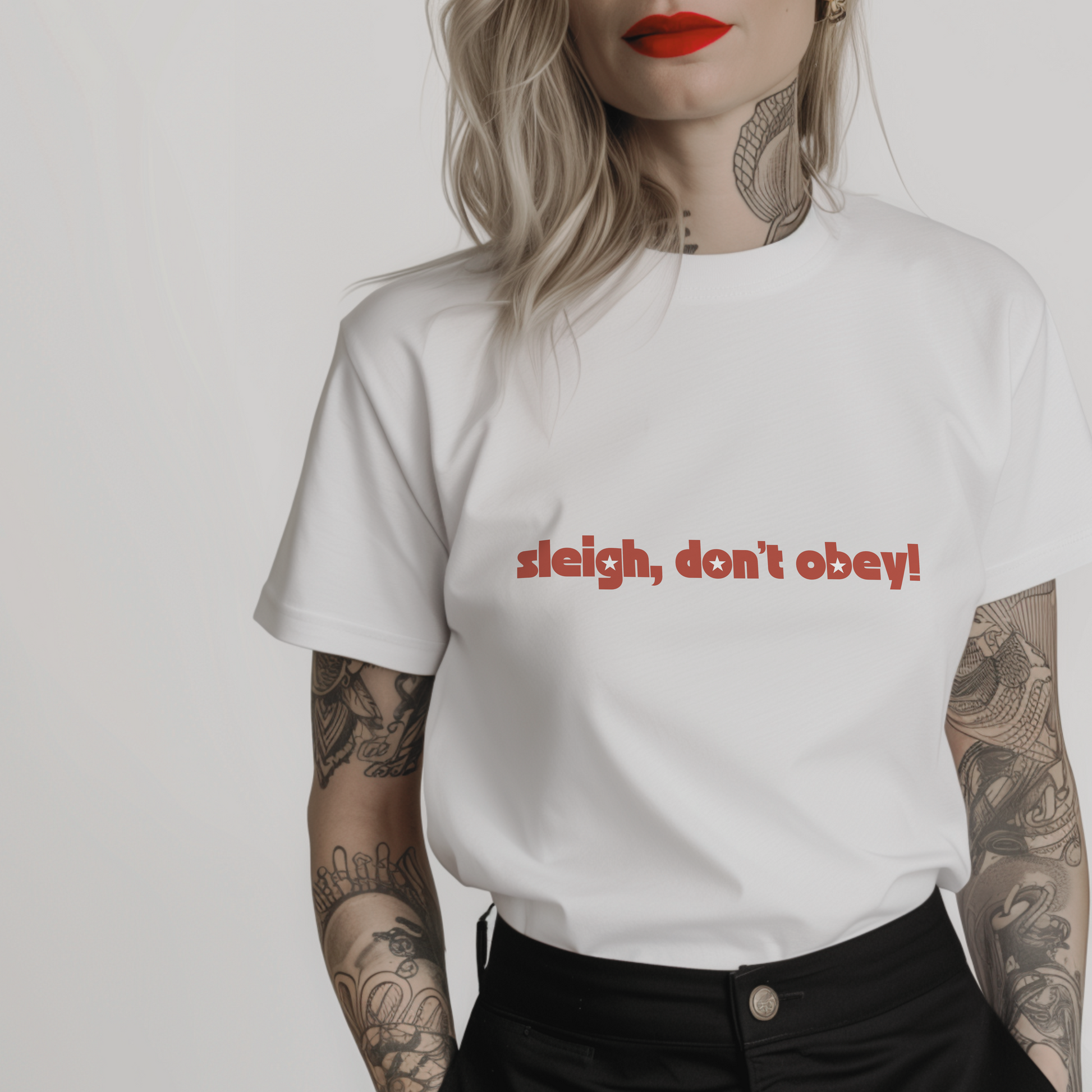 Women’s minimalist t-shirt with the feminist quote 'sleigh, don’t obey!' in a simple design and white color.