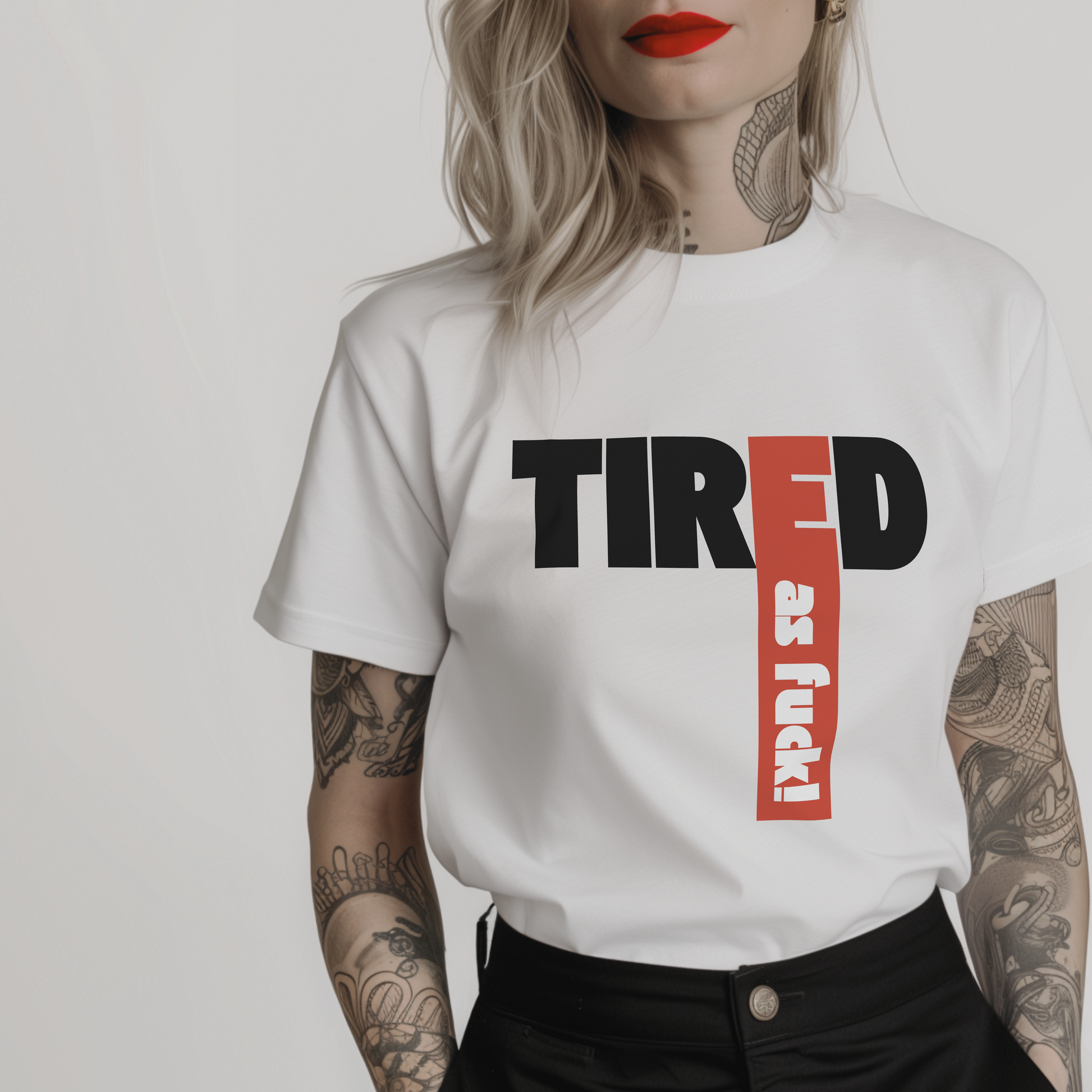 Women’s minimalist t-shirt with the quote 'Tired as fuck!' in a simple design and white color.